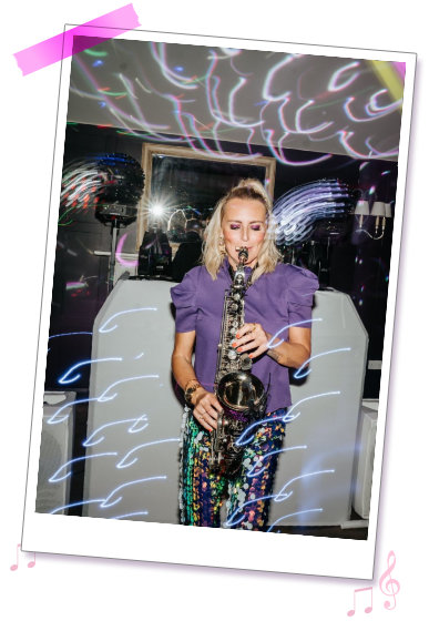 Kay stood with Sax infront of a retro 1997 background