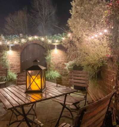 One of the tables outside the Bakehouse at night with a candle lit lantern