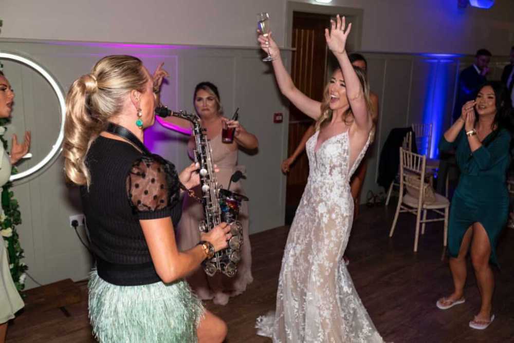 Sister Sax playing Sax ands Dancing with the Bride and wedding party on the dance floor