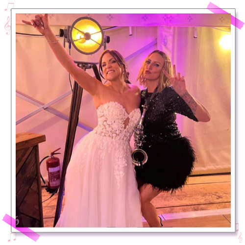 Kay with Steph and Andrew on the black and white chequered dance floor at their wedding