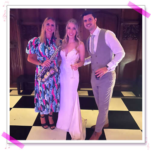Kay with Steph and Andrew on the black and white chequered dance floor at their wedding